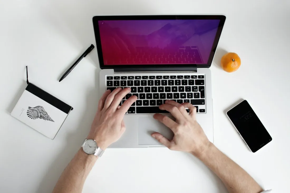 Working on a laptop in a compact desk workspace