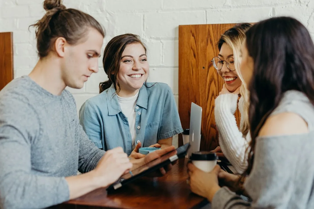 Team discussing work around a laptop