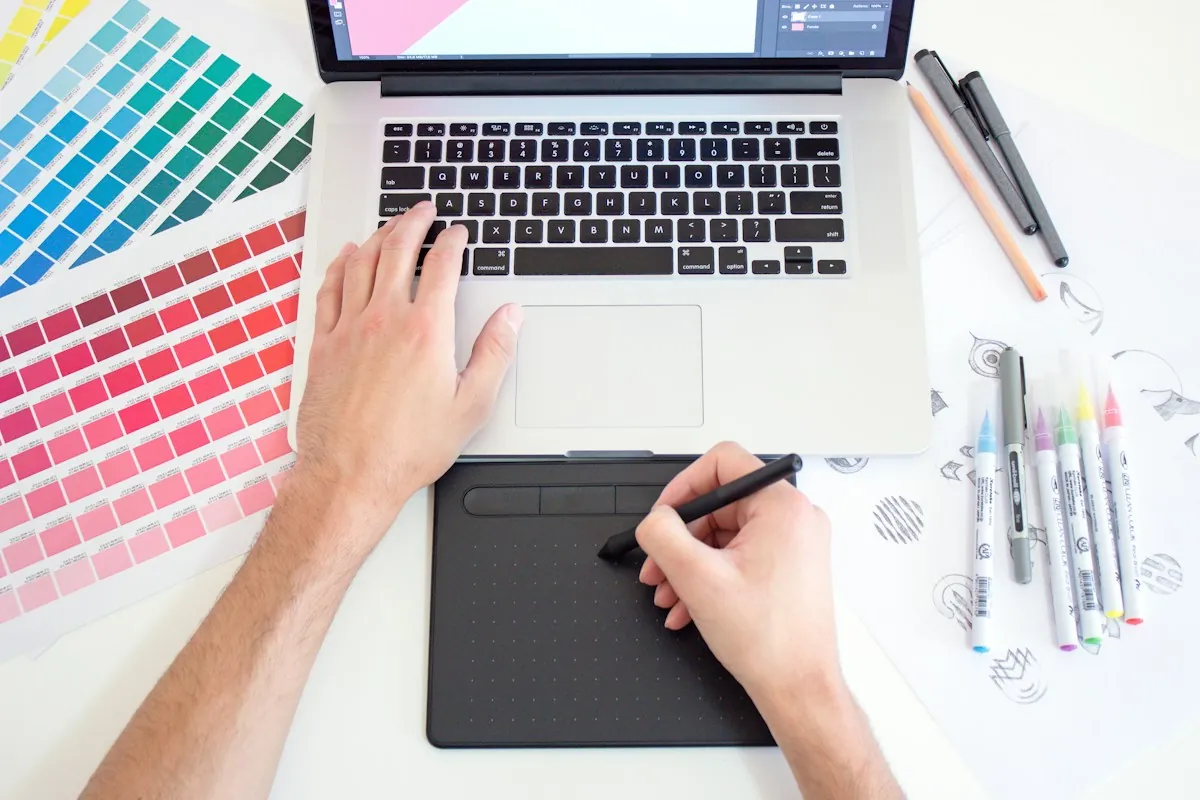 Designer using a drawing tablet and colour swatches